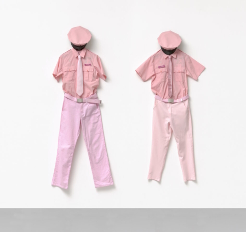 Julia Scher, Security by Julia Uniforms, 1998. Pink shirts with “Security by Julia” embroidery, pink sets of trousers, pink belts, pink ties, name tags. Courtesy the artist and Esther Schipper Belin/Paris/Seoul. Photo © Jörg von Bruchhausen.